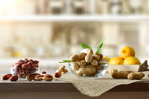 Peeled and unpeeled peanuts in glass bowls in kitchen, a Food & Drink Photo by Davizro's Market