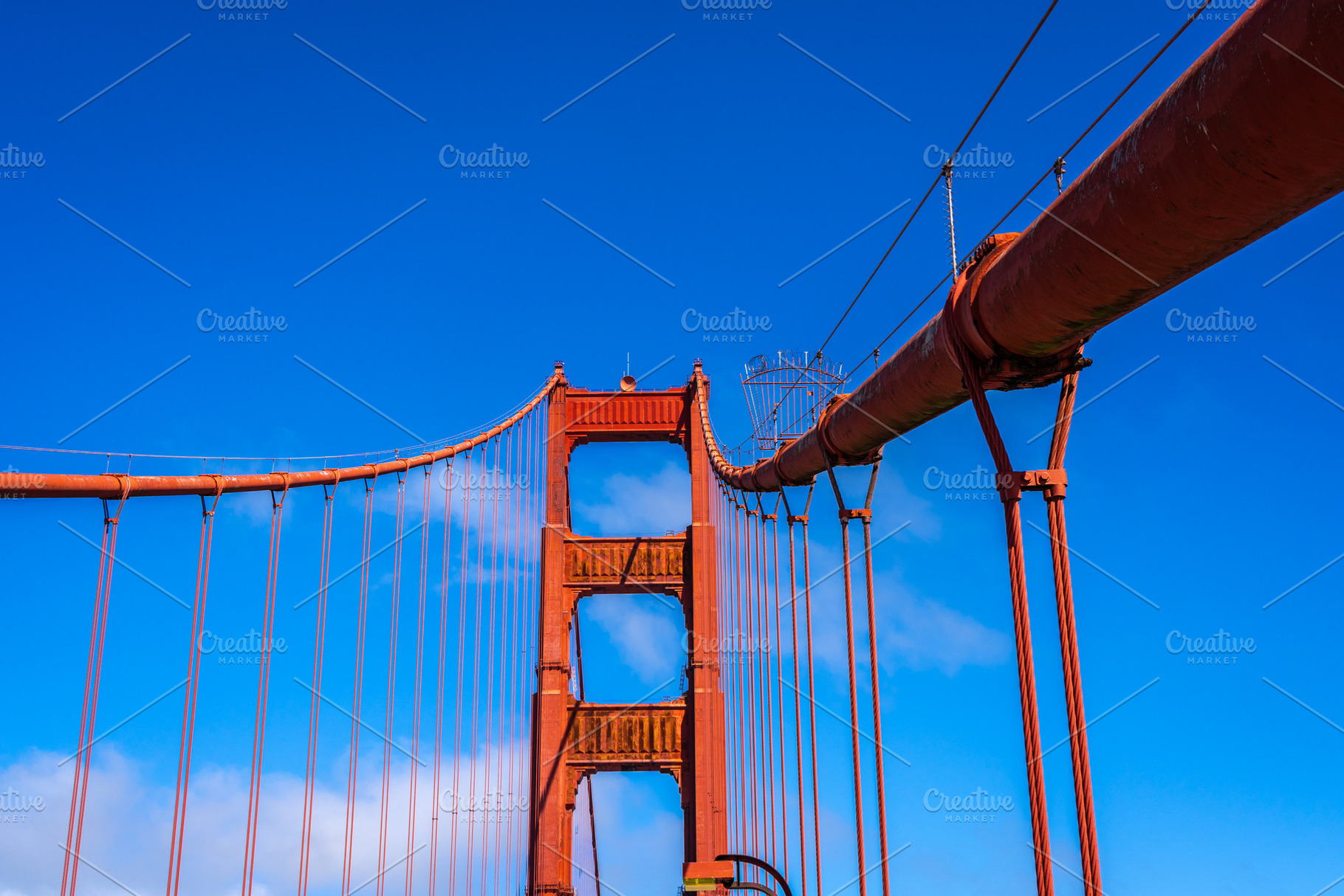 Golden Gate Bridge pedestrian walkway with red cables and blue s, an Architecture Photo by GoodGoods