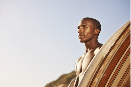 African male surfer with a surfboard, a Person Photo by Lermont51
