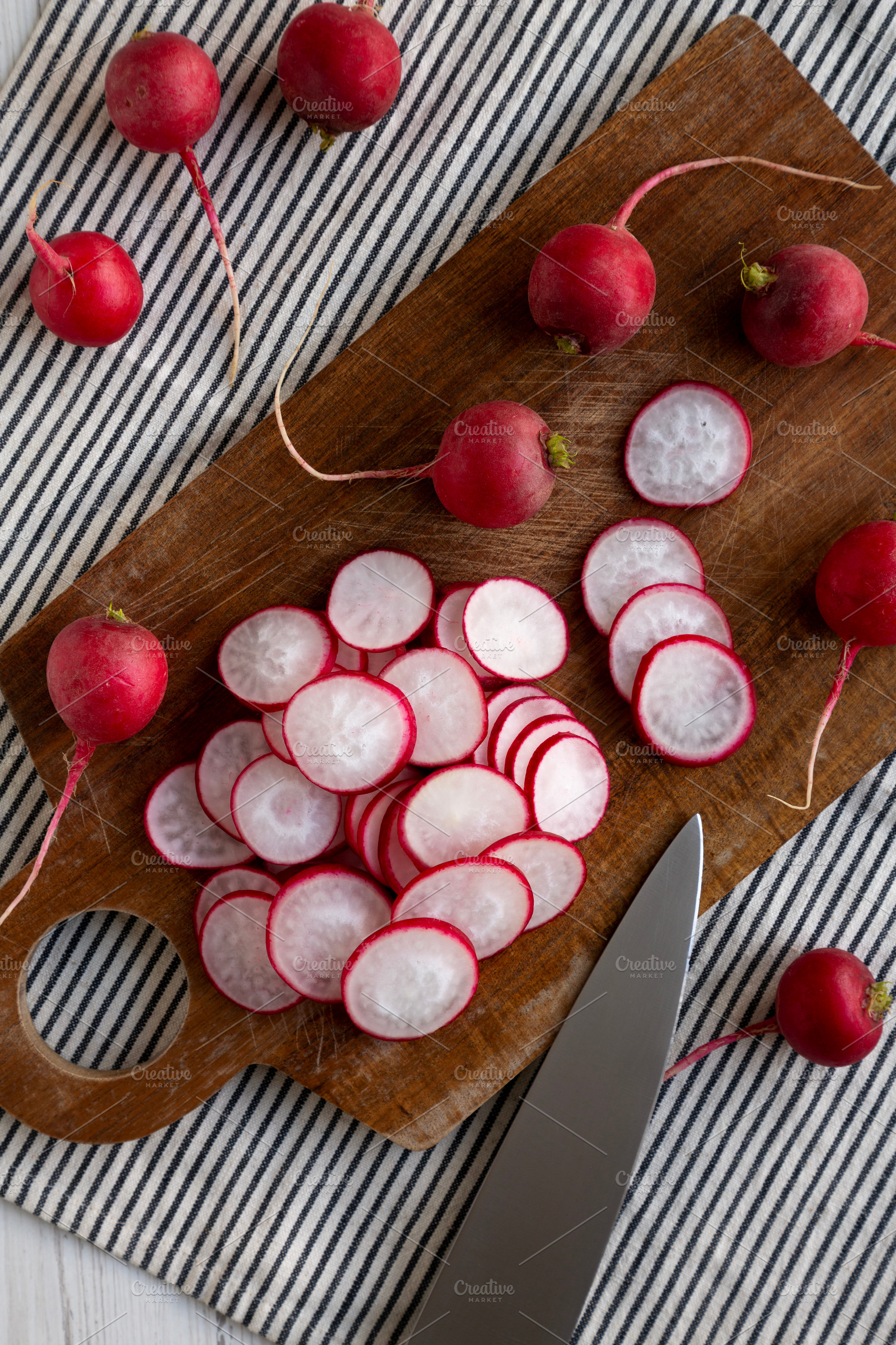 Raw Red Radish Slices on a Cutting Board, top view., a Food & Drink Photo by LiudmylaChuhunova