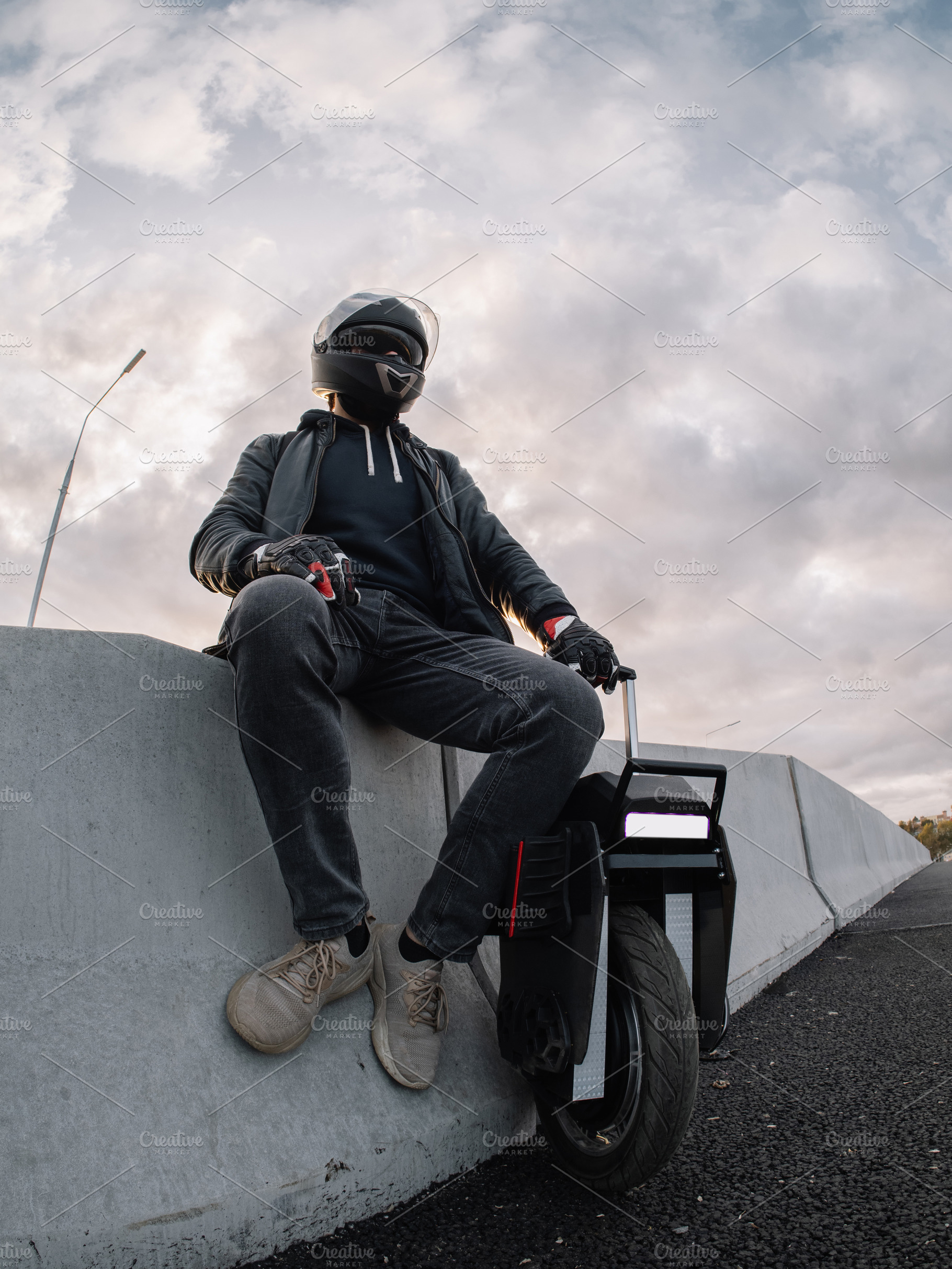 A male rider in protective gear riding an electric wheel. Urban, a Person Photo by PavelKant