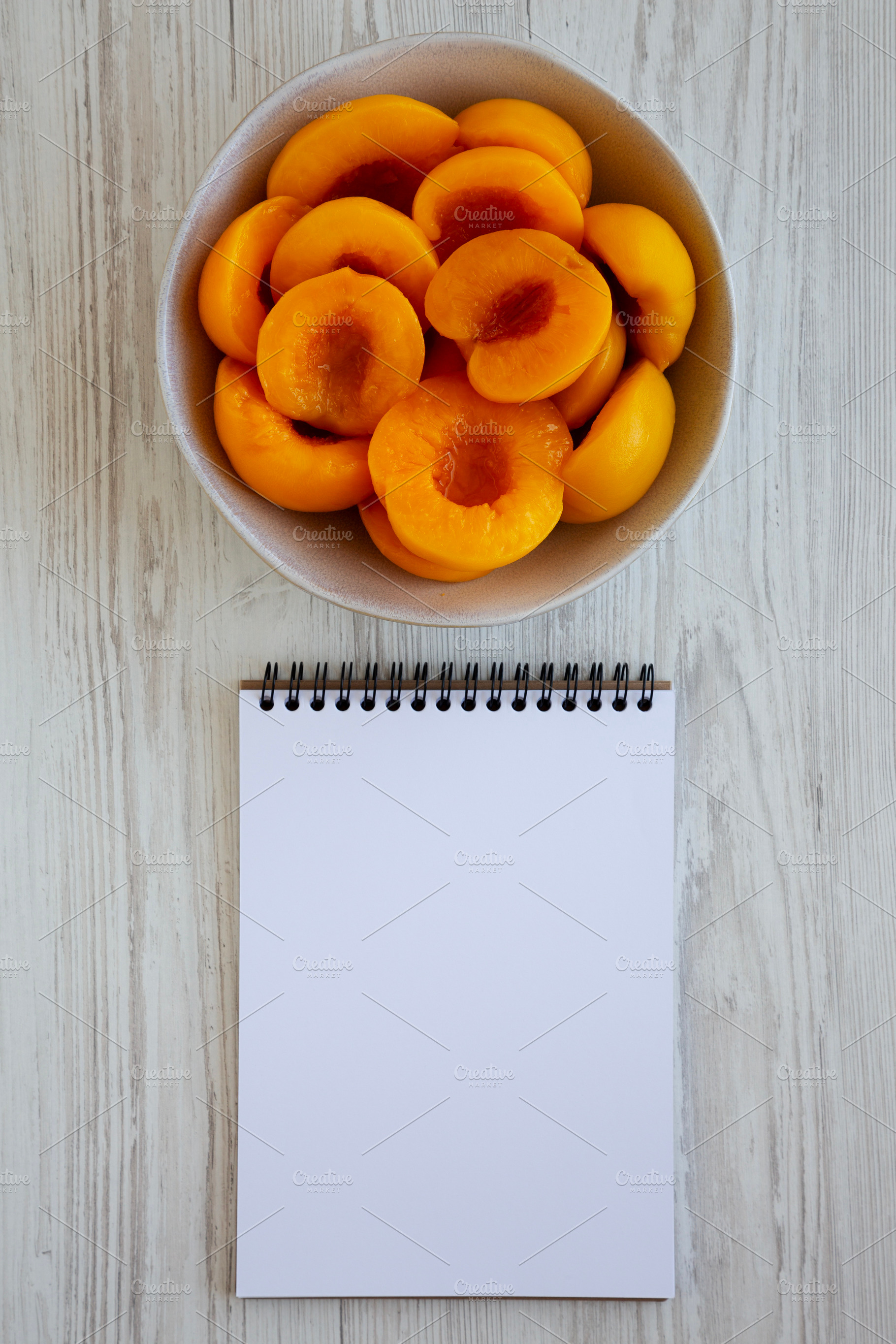 Healthy Organic Canned Peach Halves in a Bowl, blank notepad, to, a Food & Drink Photo by LiudmylaChuhunova