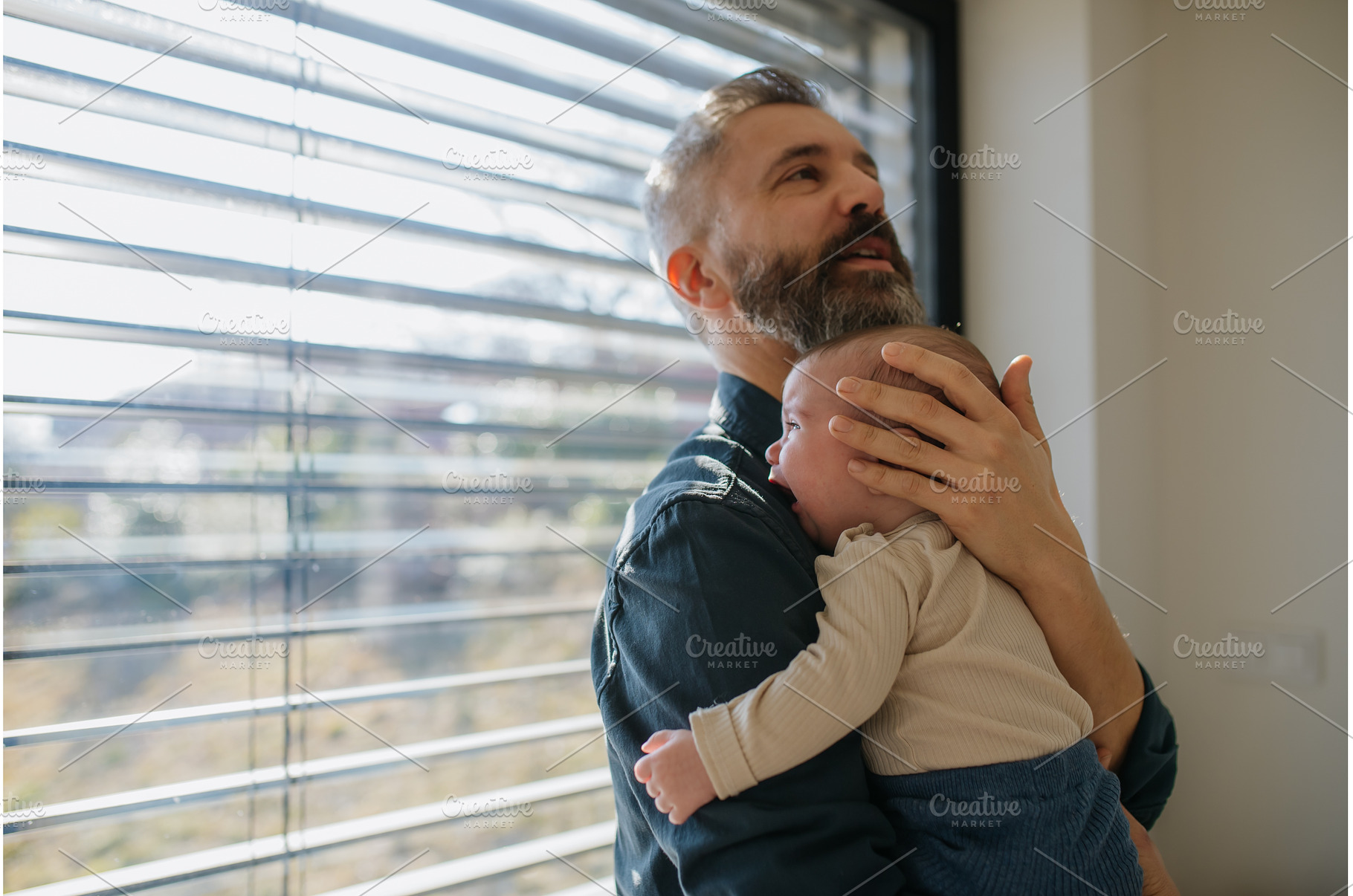 Father comforting his crying baby, a Person Photo by HalfPoint