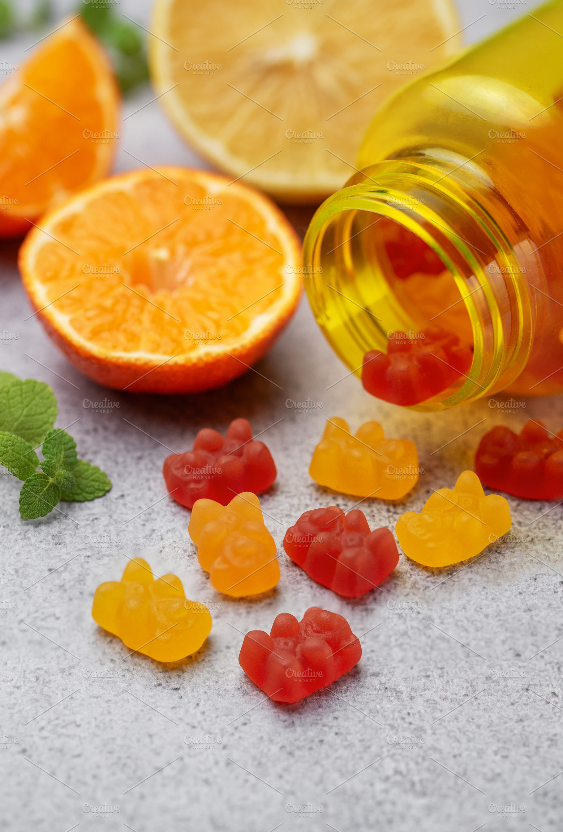 Chewable gummy vitamins and fresh oranges, a Health & Medical Photo by Olena Rudo