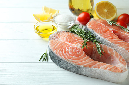 Concept of cooking salmon on white wooden table, a Food & Drink Photo by AtlasStudio PRO