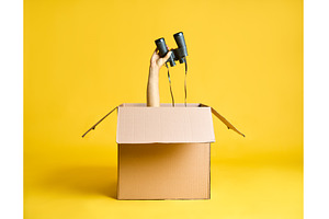 Hand holding binoculars raised up, a Technology Photo by Gladkov photography
