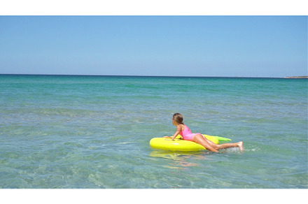 Adorable girl on inflatable air, a Person Photo by travnikovstudio