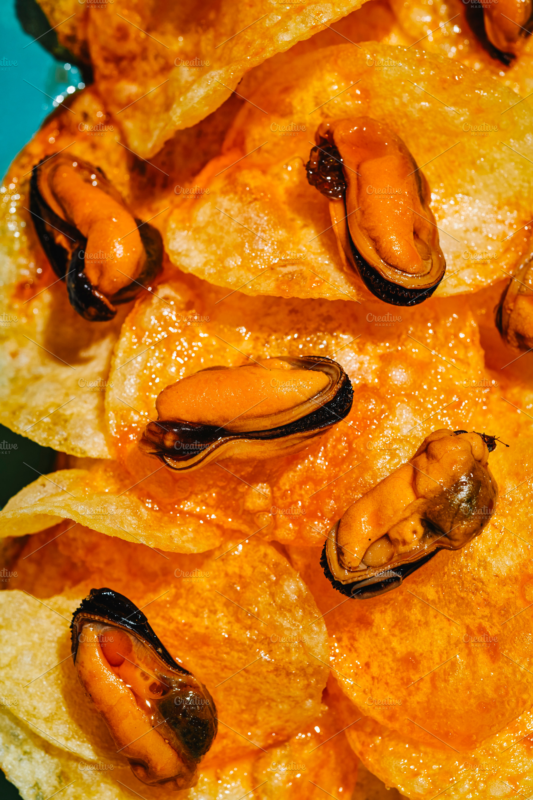 glossy mussels on escabeche-soaked potato chips, a Photo by Nito