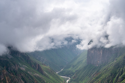 Colca Canyon and river in the mist and clouds, Peru
