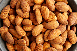 Roasted Almonds in a Bowl, top view. Flat lay, overhead, from ab, a Food & Drink Photo by LiudmylaChuhunova