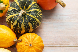 Autumn pumpkins and gourds on wooden background with leaves, a Food & Drink Photo by Olena Rudo