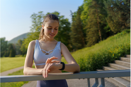 Young sporty woman checking her, a Sports & Recreation Photo by HalfPoint