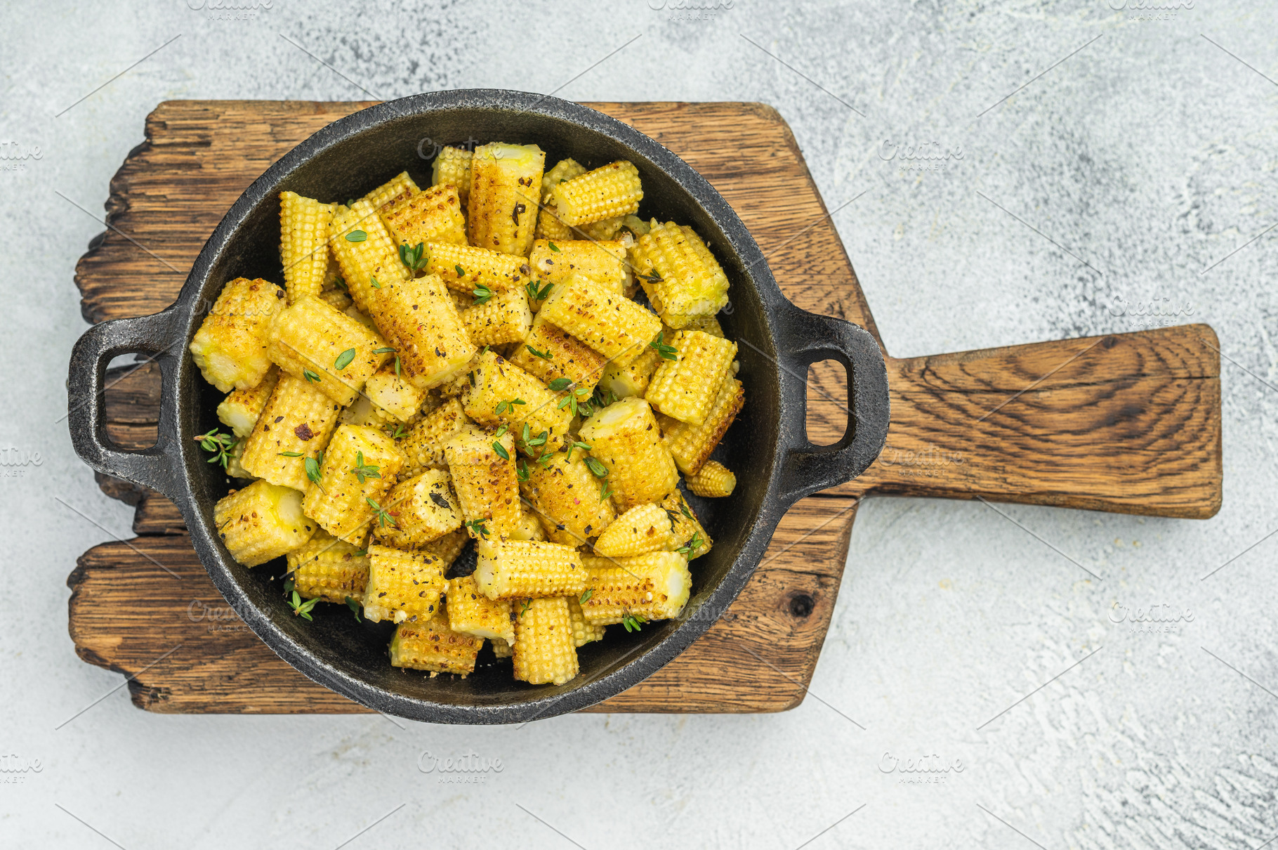 Roasted baby corn sliced into pieces with seasoning and thyme in, a Food & Drink Photo by composter-box@mail.ru