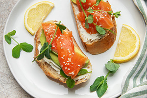 Salmon avocado toasts with cream cheese and microgreens, a Food & Drink Photo by Olena Rudo