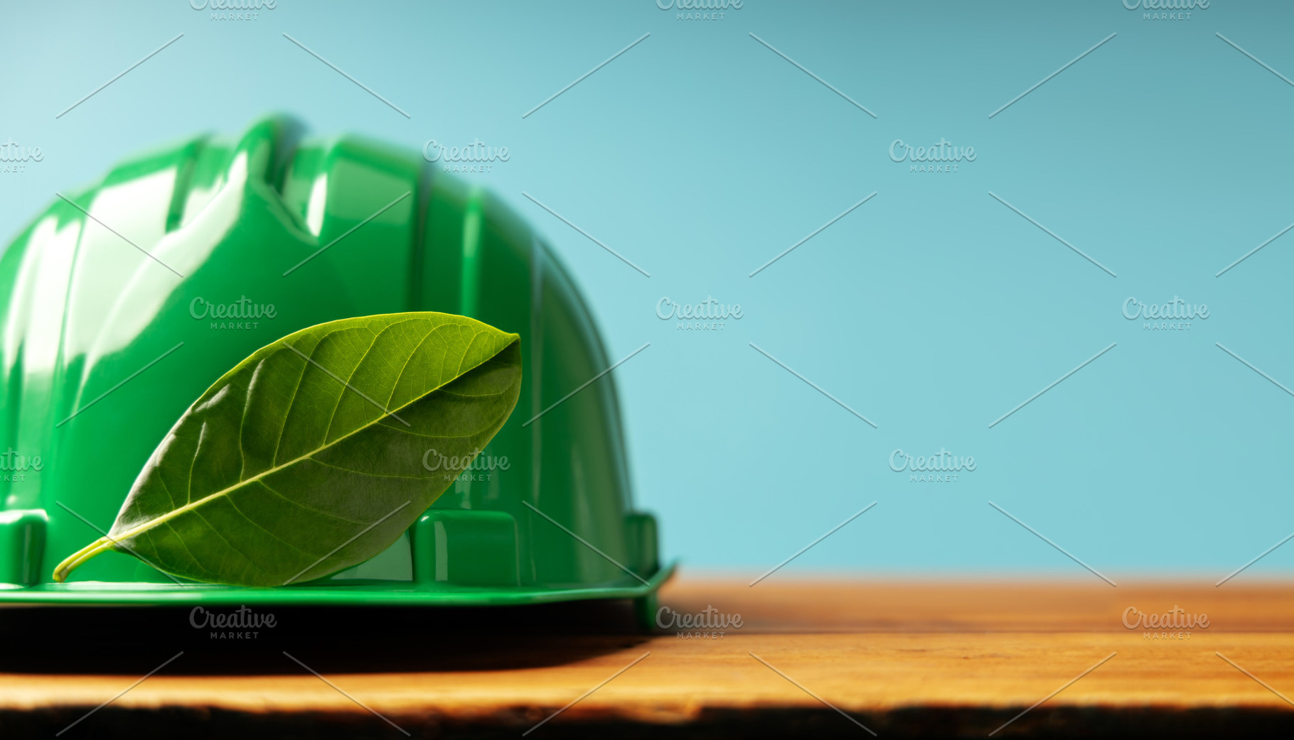 ESG and Clean Energy Concept. Hard Hat with a Green Leaf. Produc, a Photo by salmon.black