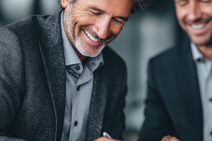 Happy businessman signing documents, a Photo by Pixeness Studio
