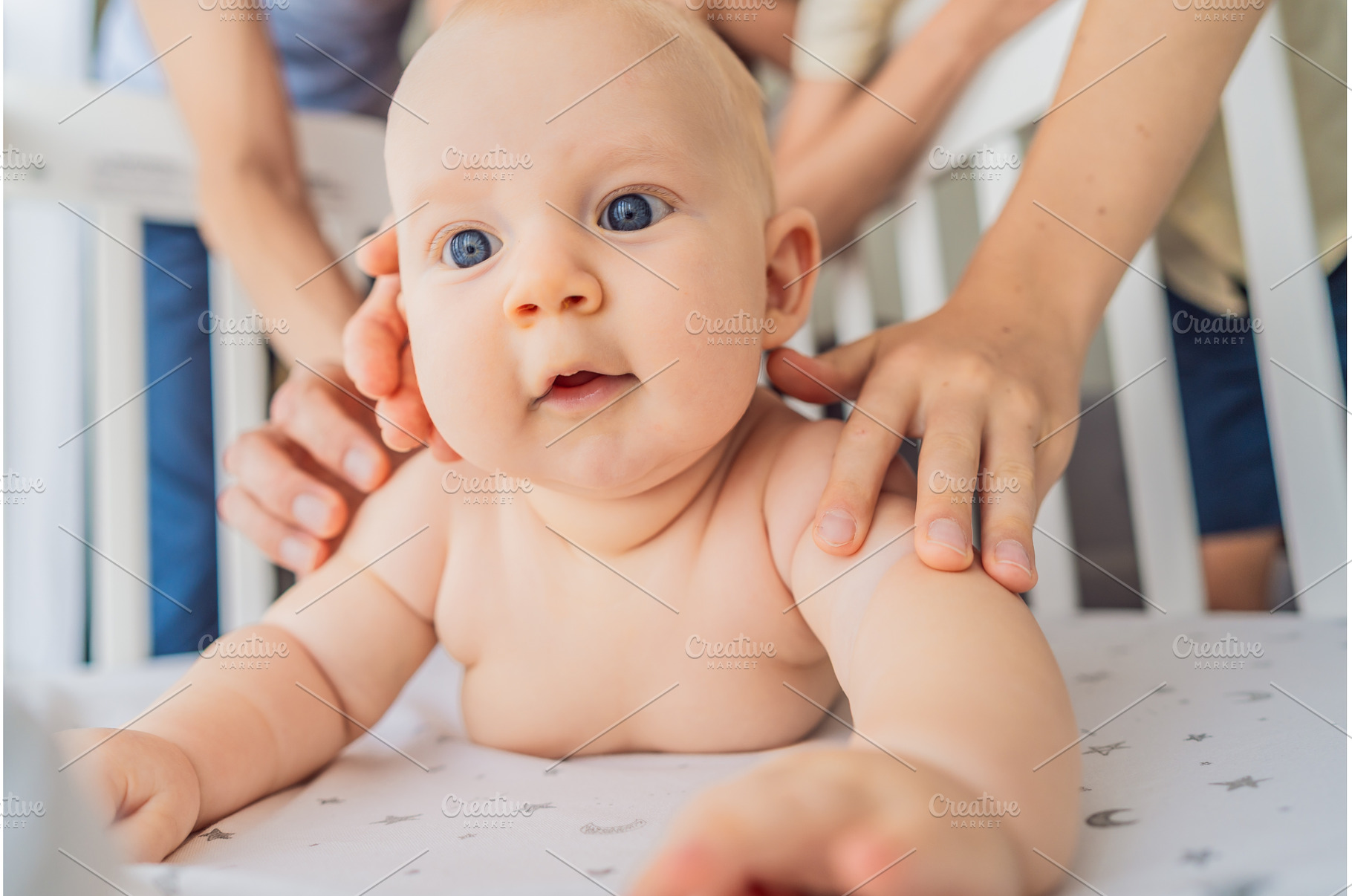 Baby lying on stomach in crib with, a Beauty & Fashion Photo by Elizaveta Galitskaya