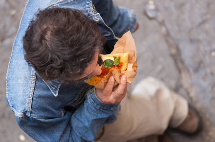 Man photographed from above eating a
