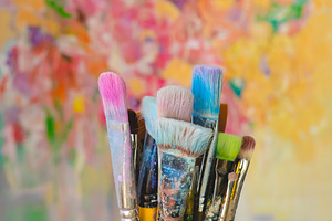 Paint brushes and colorful canvas