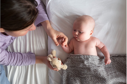 Baby boy resting in bed playing with, a Person Photo by Koldunova