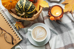 Autumn cozy moment with coffee, candle, and pumpkins, a Food & Drink Photo by Olena Rudo