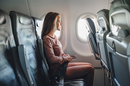 Girl is strapped on the plane stock photo containing airplane and seat