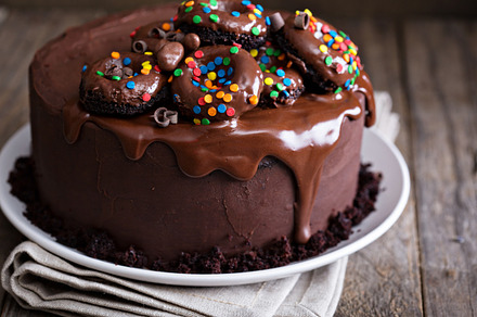 Chocolate cake decorated with donuts featuring chocolate, cake, and glaze, a Food & Drink Photo by farwasser