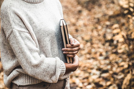 Woman holds a book in her hands, a School & Education Photo by OS