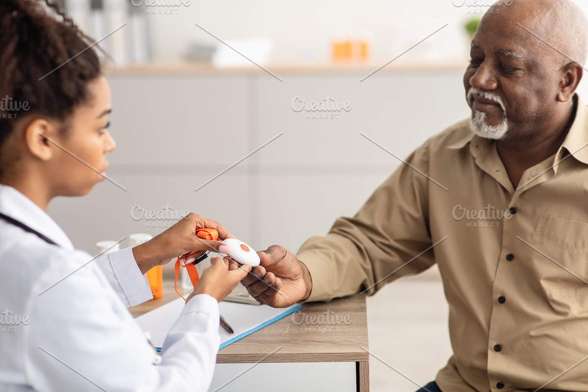 Emergency call system. Doctor giving Alarm Button to Senior Man, a Photo by Prostock-Studio (Photo 2 of 2)