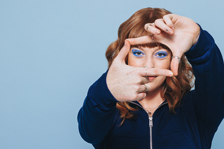 Woman making a finger frame in a studio