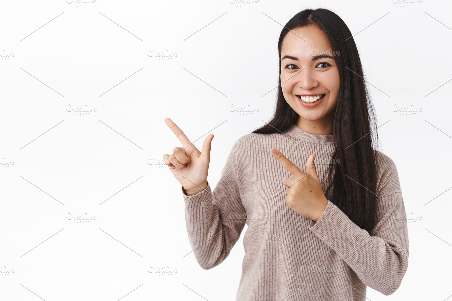 Smiling asian girl pointing left, a Person Photo by Cookie Studio