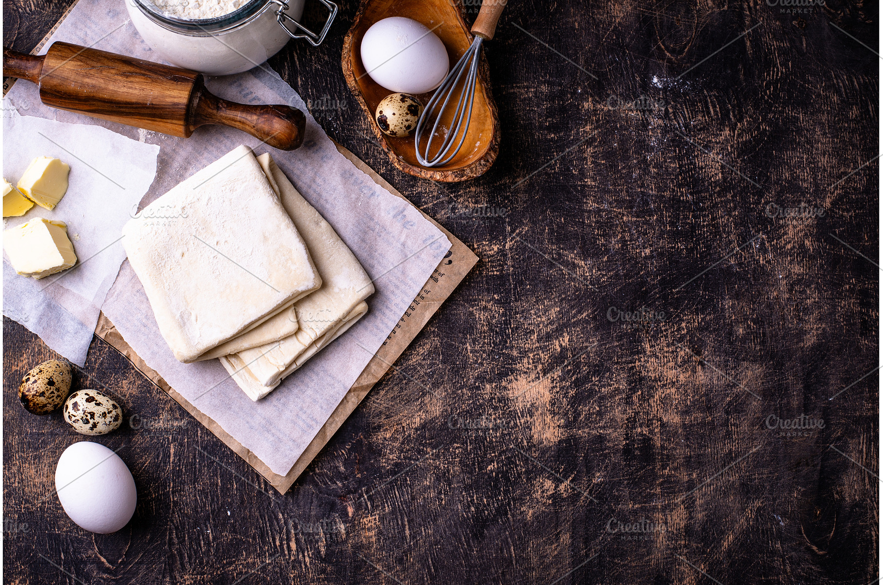 Raw puff pastry dough with baking, a Food & Drink Photo by Yulia Furman
