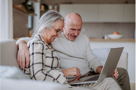 Senior couple sitting on sofa and, a Person Photo by HalfPoint
