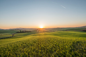 Sunset over idyllic tuscany meadows stock photo containing tuscan and tuscany
