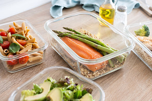Healthy meal prep containers with salmon, chicken, pasta and fresh vegetables, a Food & Drink Photo by etorres69