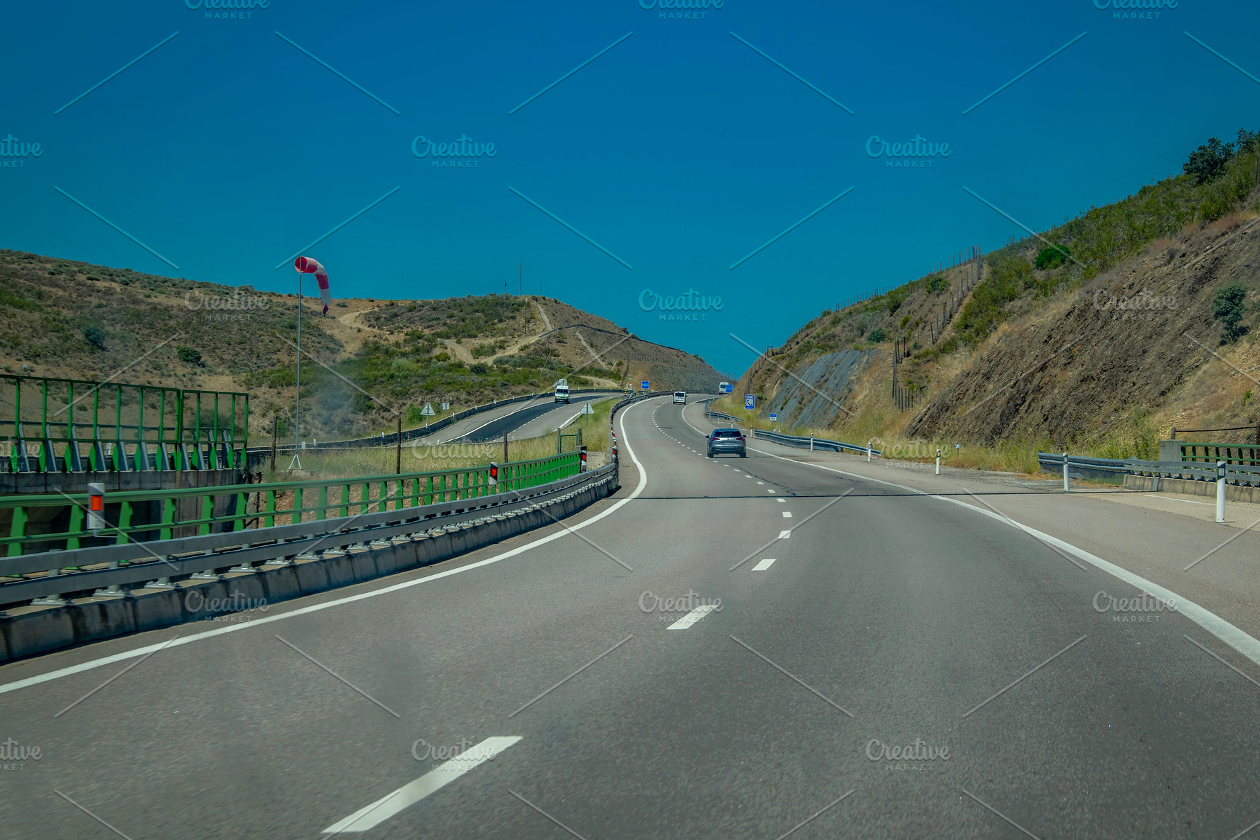 Curving highway through hills, a Transportation Photo by DanFLCreativo