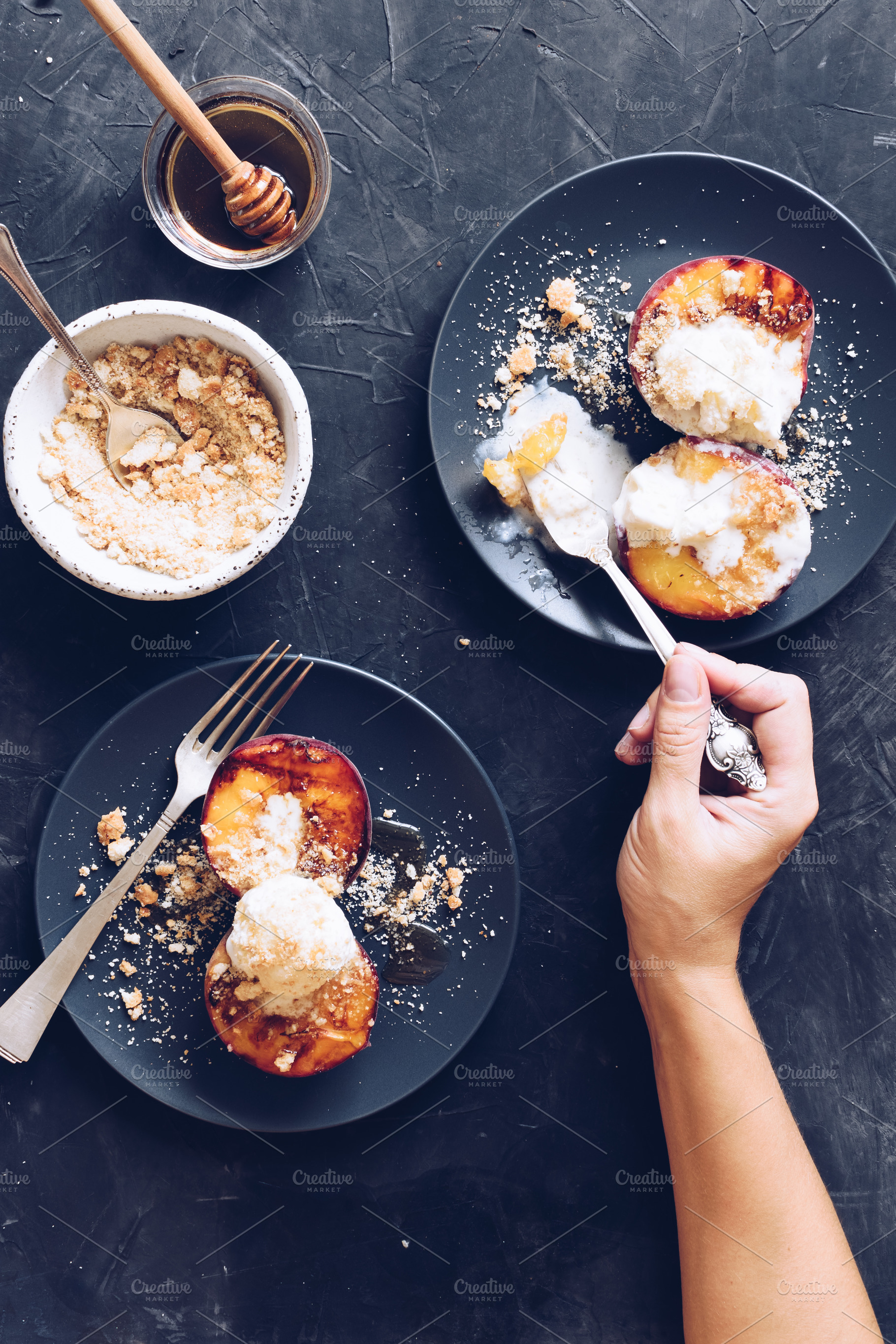 Grilled peaches and ice cream containing hand, woman, and female, a Food & Drink Photo by NelliKovalchuk