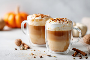 Warm spiced pumpkin beverages served in clear glass cups for autumn enjoyment, a Food & Drink Photo by AlyaAnd