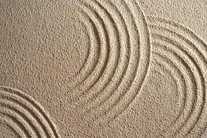 Textured sand with circular wave patterns, a Background Photo by AlyaAnd