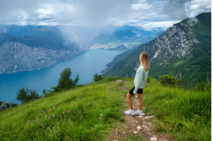 Woman tourist standing on a mountain, a Person Photo by den-belitsky