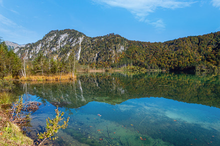 Peaceful autumn Alps mountain lake with clear transparent water, a Nature Photo by YuriyB