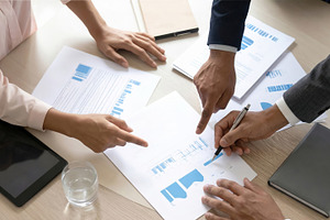 Business Team Reviewing Financial Charts Together, a Business Photo by Davizro's Market