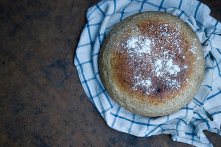 Home cooked round bread, on a dark background. View from above