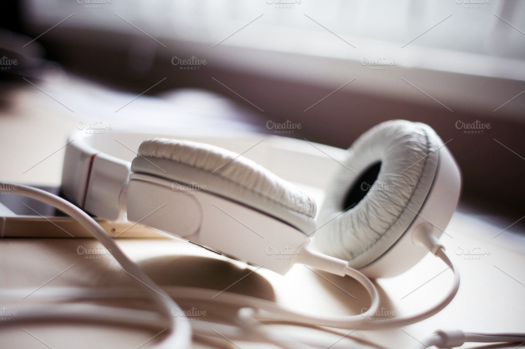 Just White Headphones Featuring Iphone Desk And Headphones