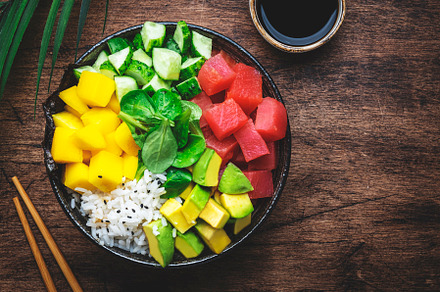 Poke bowl with fresh tuna, avocado, mango, cucumber, lettuce and, a Food & Drink Photo by 5PH