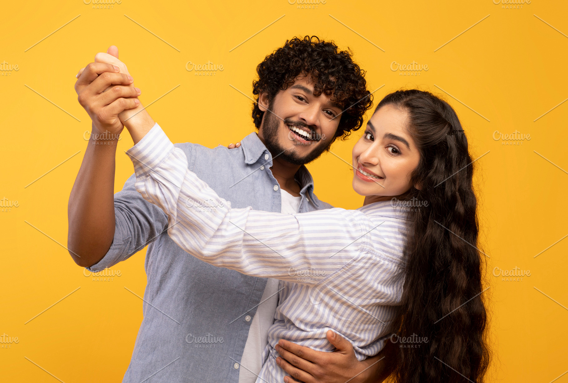 Romantic happy indian husband and wife hugging, holding hands and dancing, havi, a Photo by Prostock-Studio