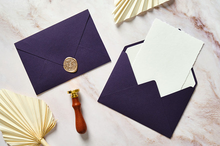 Wedding stationery set. Blank paper card, purple envelopes, dried flowers, wax, a Holiday Photo by photoguns