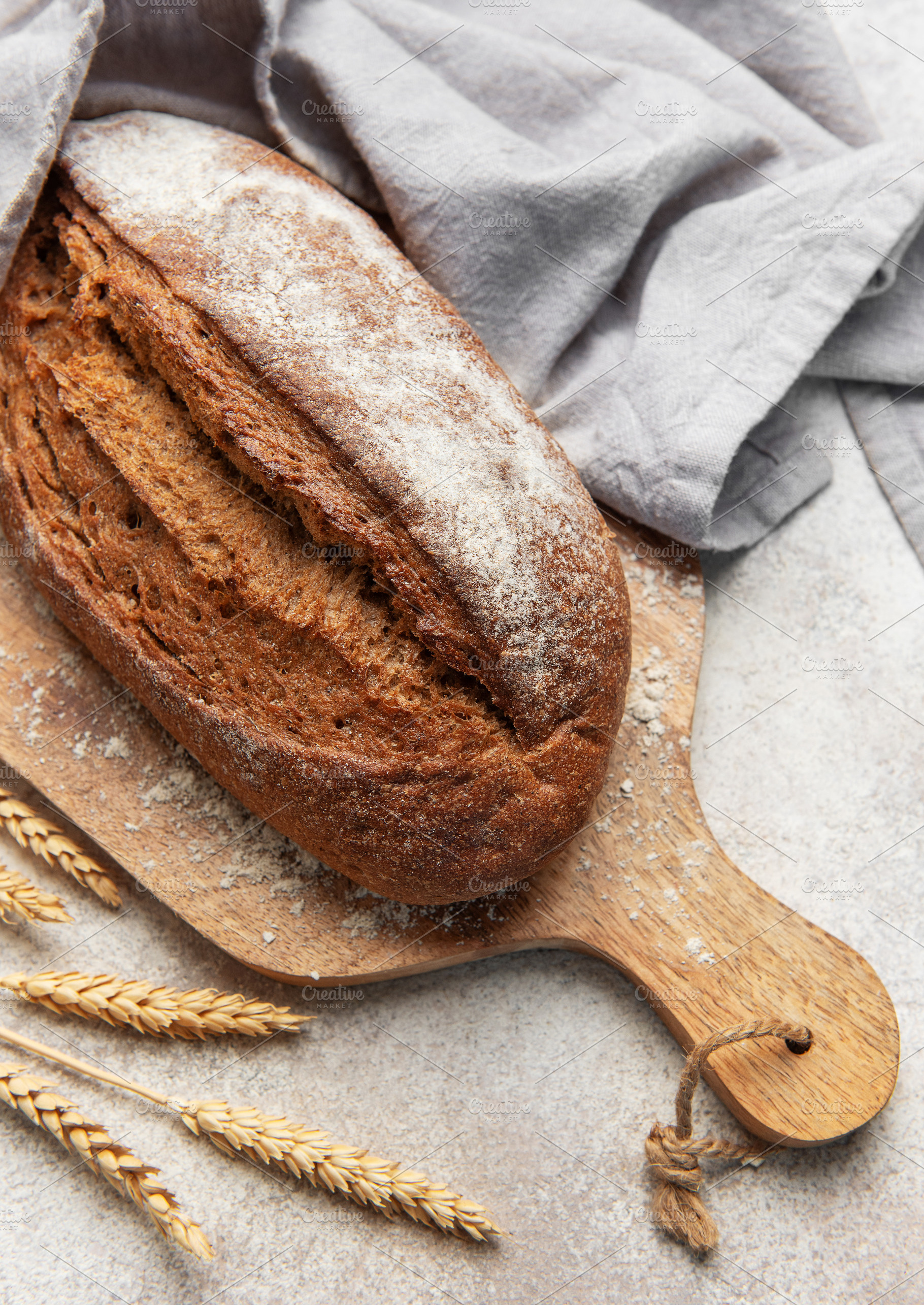 Fresh baked rye bread loaf on wooden board, a Food & Drink Photo by Olena Rudo
