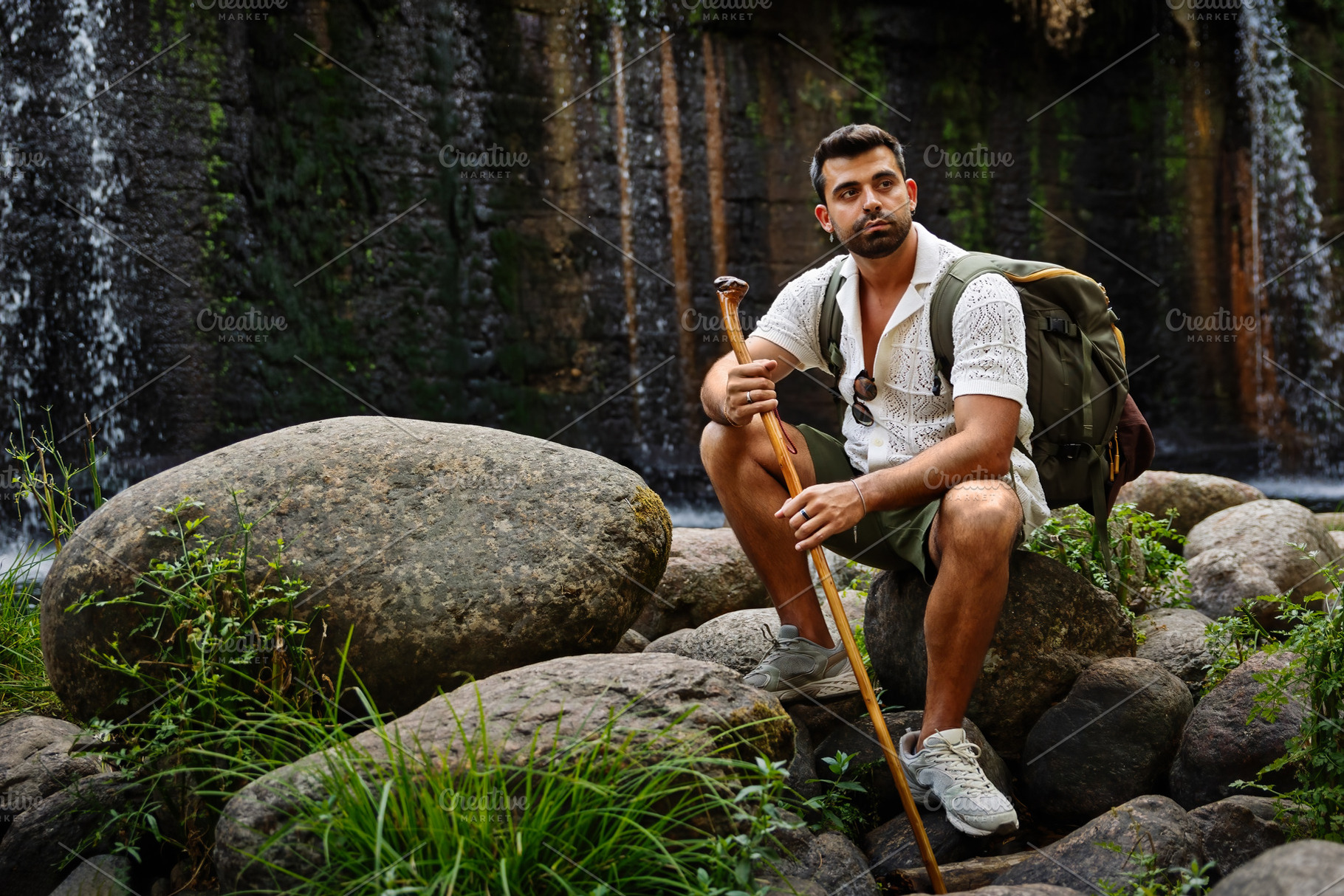 Hiker contemplating a waterfall whil, a Person Photo by Perpis