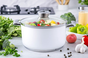 White pot with mixed vegetables in m, a Photo by Dvoevnore photos